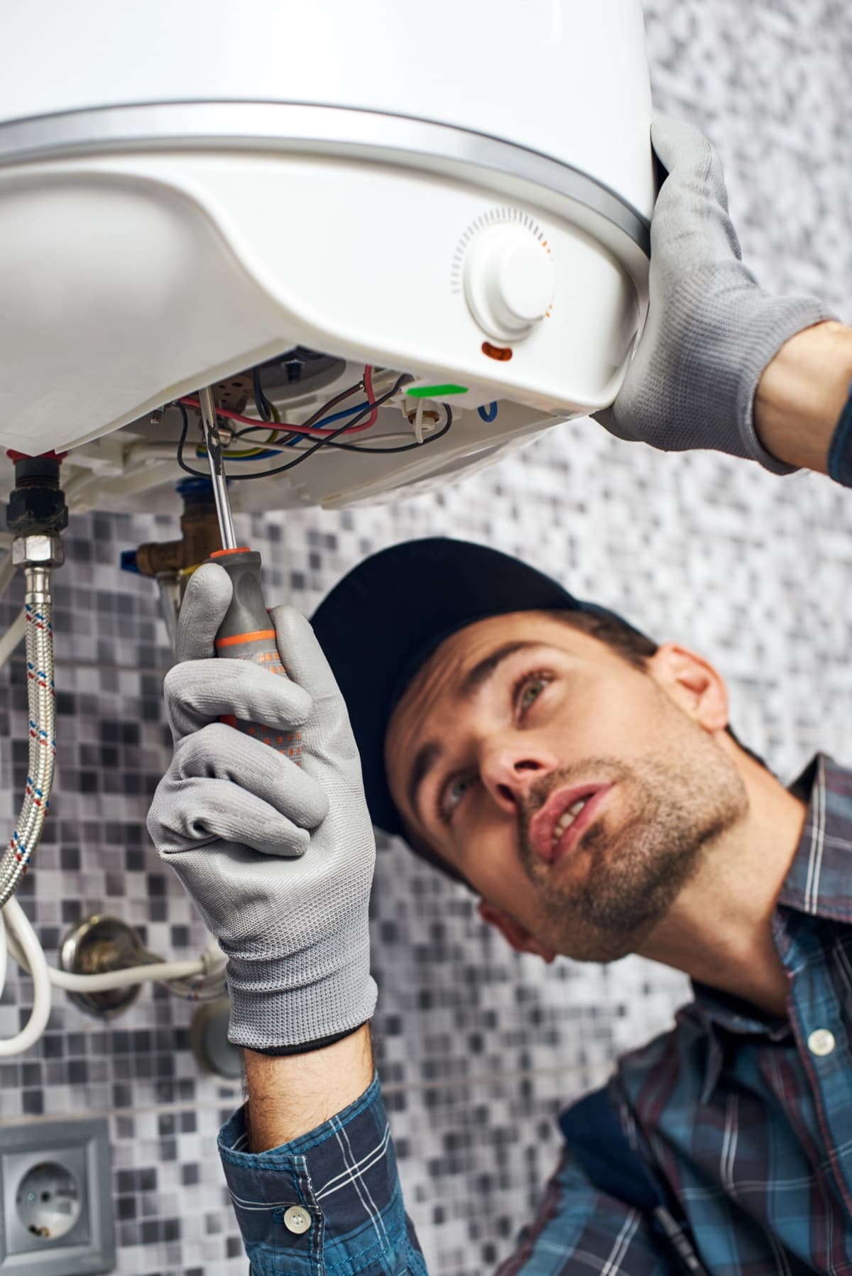 Technician servicing a water heater